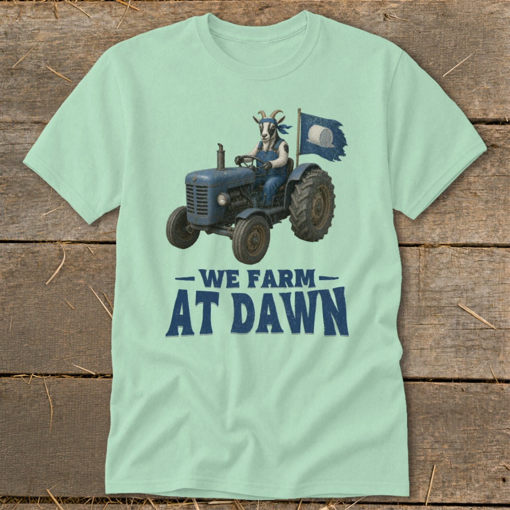 Goat driving a tractor with flag, "We Farm At Dawn" text.