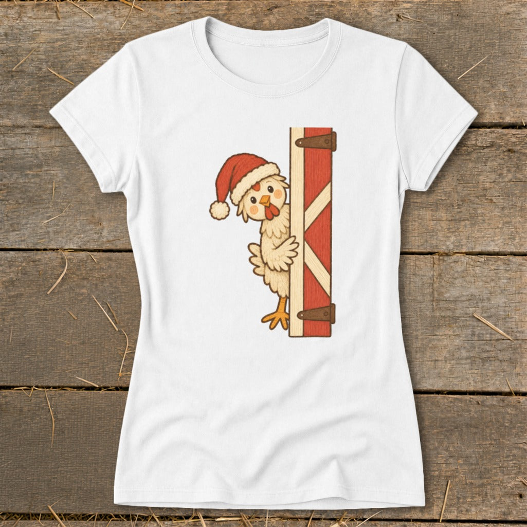 White t-shirt with cartoon chicken wearing Santa hat peeking from behind barn door.