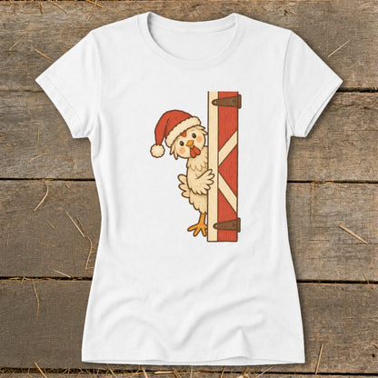 White t-shirt with cartoon chicken wearing Santa hat peeking from behind barn door.