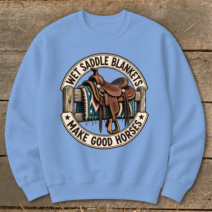 Western saddle and patterned blanket on fence with text "Wet Saddle Blankets Make Good Horses".