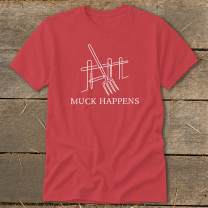 Red t-shirt with white line drawing of pitchfork and fence, text reads "MUCK HAPPENS".