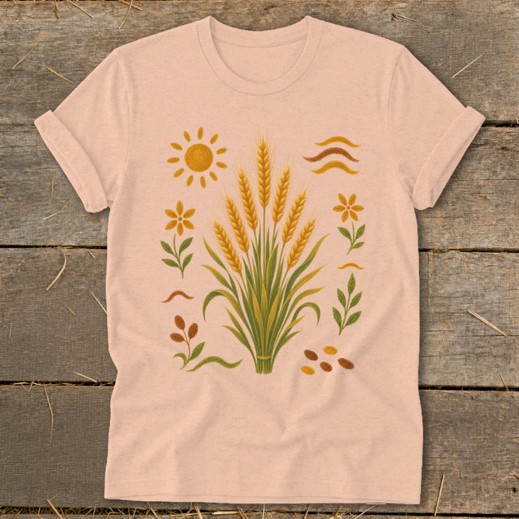 T-shirt with a graphic of wheat stalks, sun, flowers, and seeds.