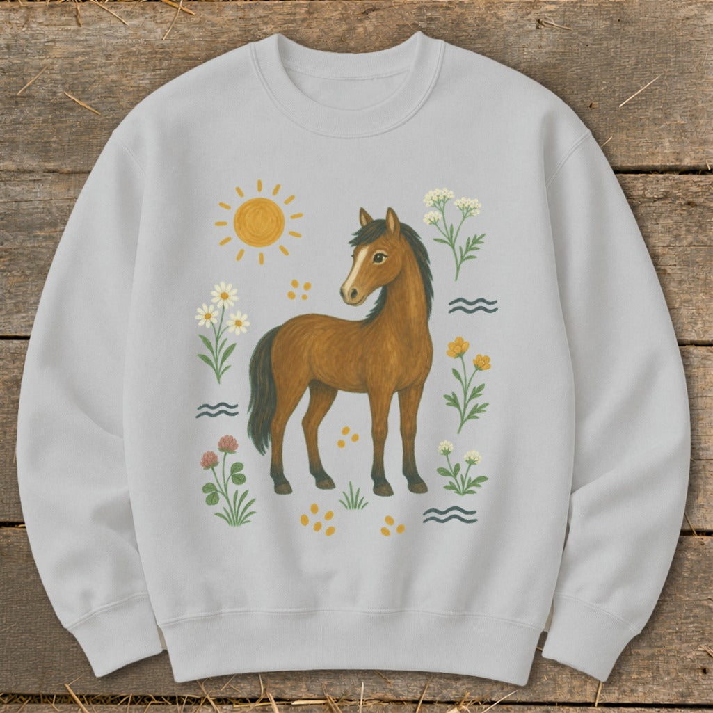 Light grey sweatshirt with a brown horse surrounded by flowers, sun, and waves.