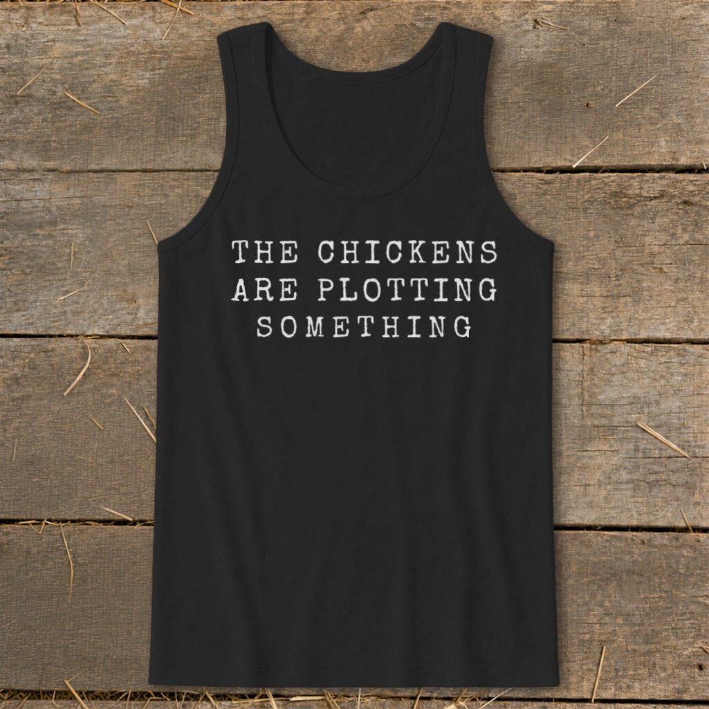 Black tank top with white text "THE CHICKENS ARE PLOTTING SOMETHING".