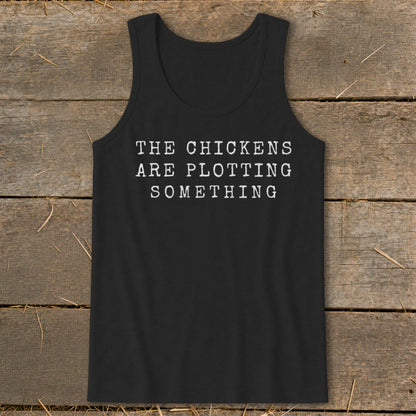 Black tank top with white text "THE CHICKENS ARE PLOTTING SOMETHING".