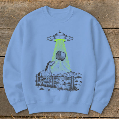 Light blue sweatshirt with a drawing of a UFO beam lifting a hay bale over a horse.
