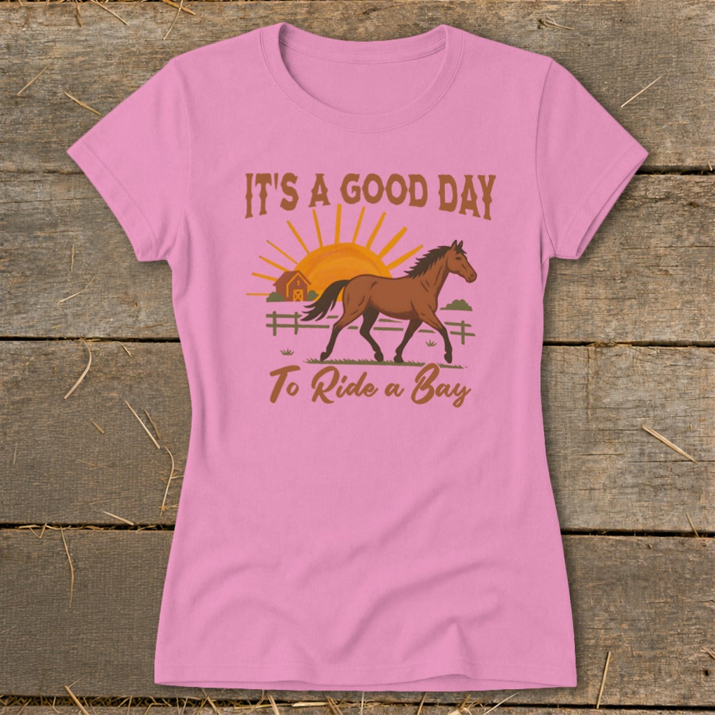 Pink t-shirt with a horse, barn, sun, and text "IT'S A GOOD DAY To Ride a Bay."
