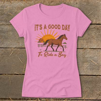 Pink t-shirt with a horse, barn, sun, and text "IT'S A GOOD DAY To Ride a Bay."
