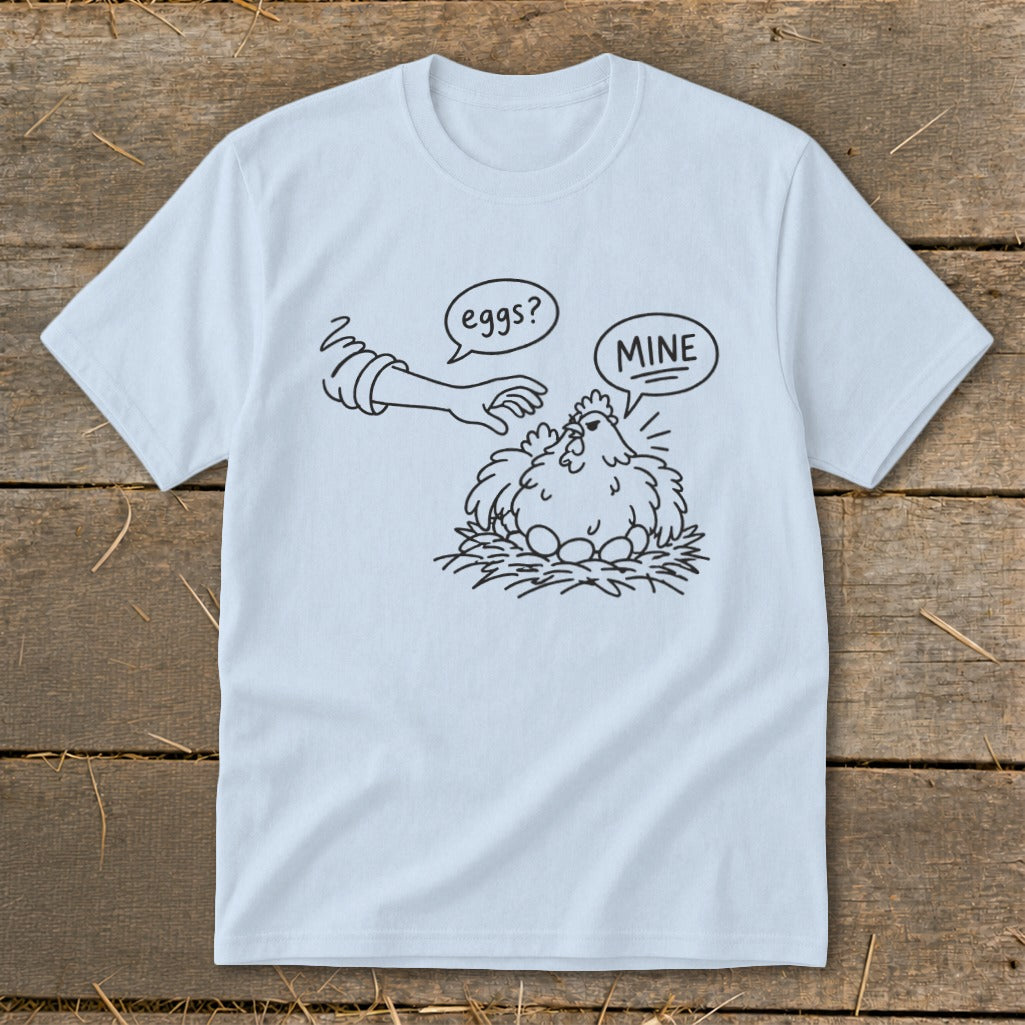 T-shirt with cartoon of hen protecting eggs, saying "MINE," with hand asking "eggs?"
