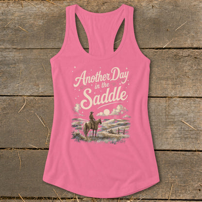 Pink tank top with "Another Day in the Saddle" graphic.