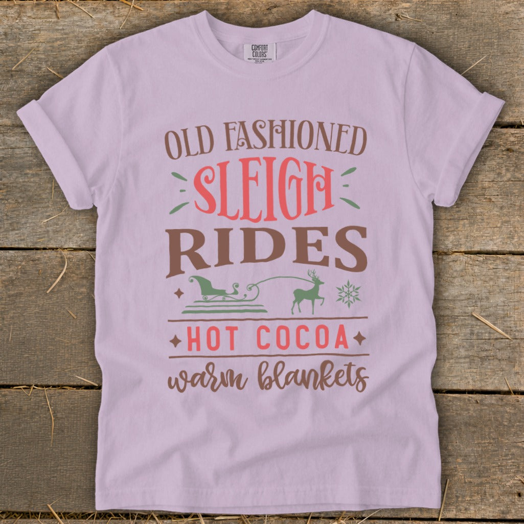 T-shirt with "Old Fashioned Sleigh Rides, Hot Cocoa, Warm Blankets" text and winter graphics.