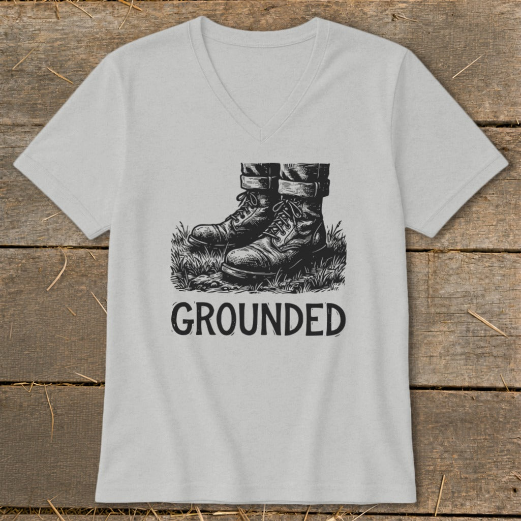 Light gray t-shirt with illustration of boots on grass and the word "GROUNDED".