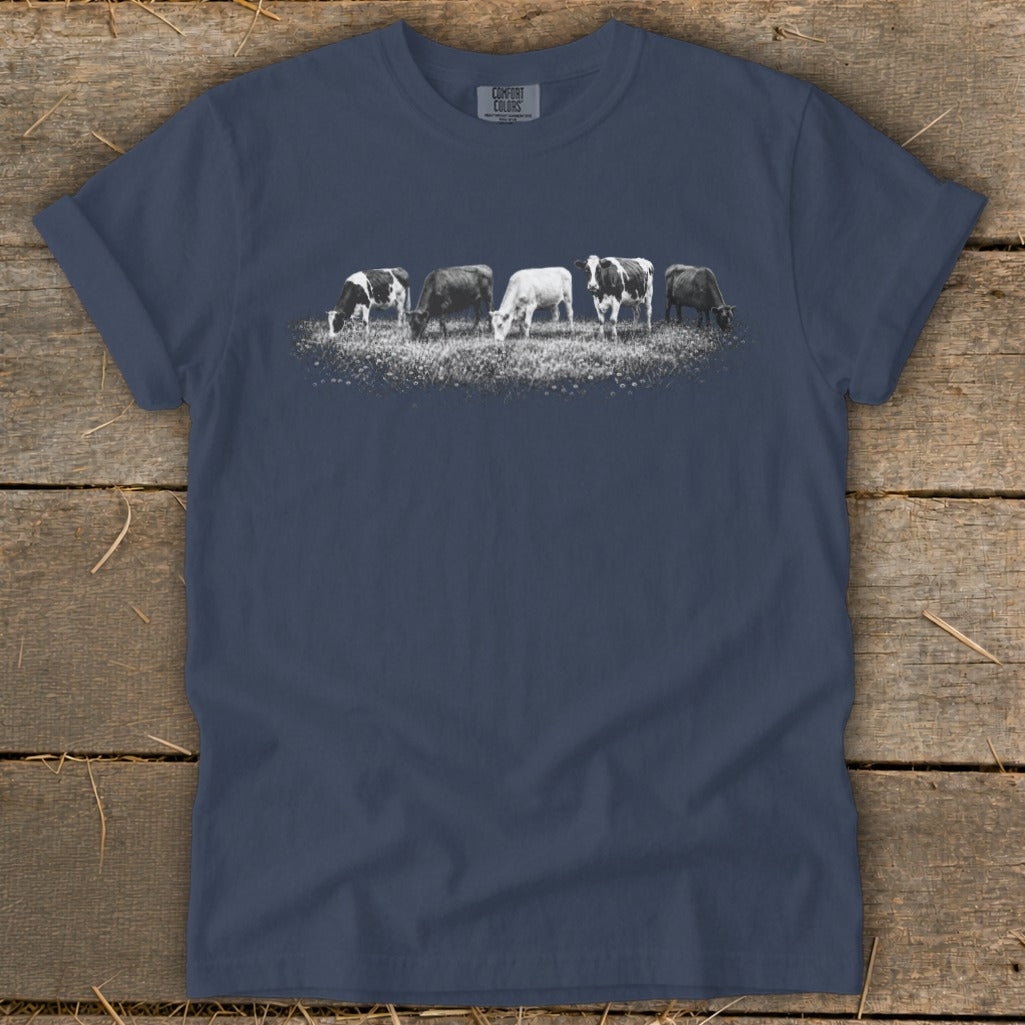 T-shirt with five cows grazing in a field with "Comfort Colors" text.