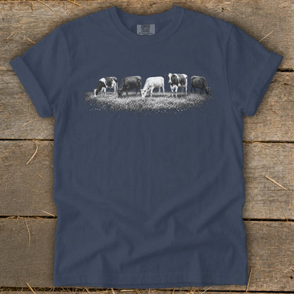 T-shirt with five cows grazing in a field with "Comfort Colors" text.