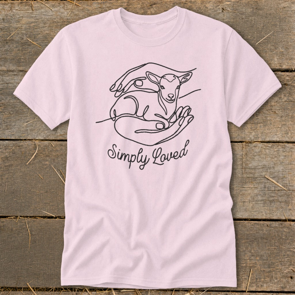 Pink t-shirt with black line art of hands holding a lamb and the text "Simply Loved".