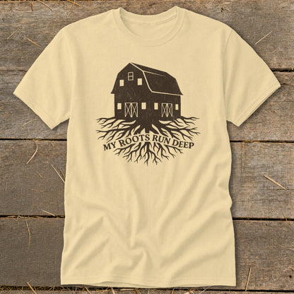 Light yellow t-shirt with a dark brown graphic of a barn and tree roots, text reads "MY ROOTS RUN DEEP".