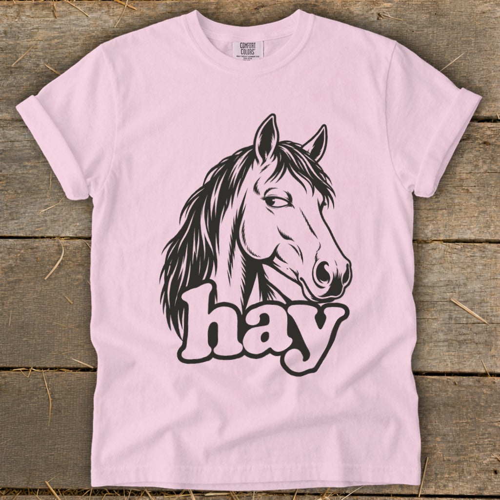 Pink t-shirt with a black horse head graphic and the word "hay" below.