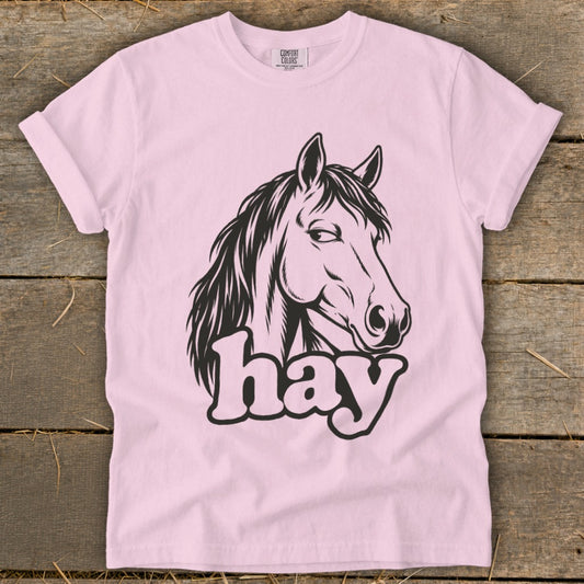 Pink t-shirt with a black horse head graphic and the word "hay" below.