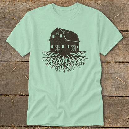 Pale green t-shirt with a dark brown barn graphic with roots and text "MY ROOTS RUN DEEP".