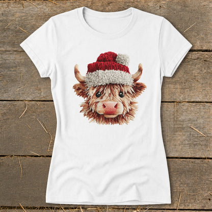 White t-shirt featuring a fluffy Highland cow wearing a Santa hat.