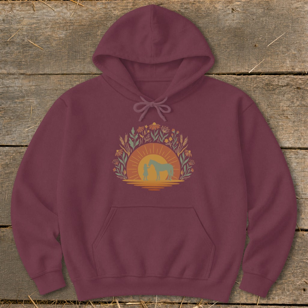 Maroon hoodie with a circular graphic of a person and horse at sunset.