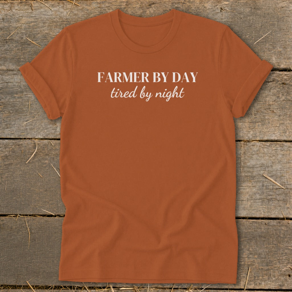 Orange t-shirt with white text "FARMER BY DAY tired by night".