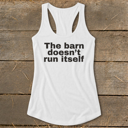 White racerback tank top with black text that reads "The barn doesn't run itself."