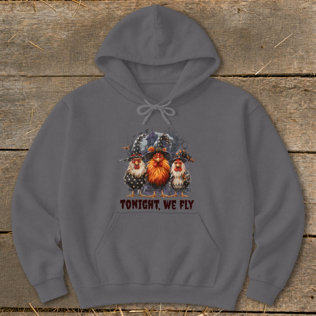 Three chickens in witch hats stand before a haunted house with text "TONIGHT, WE FLY".