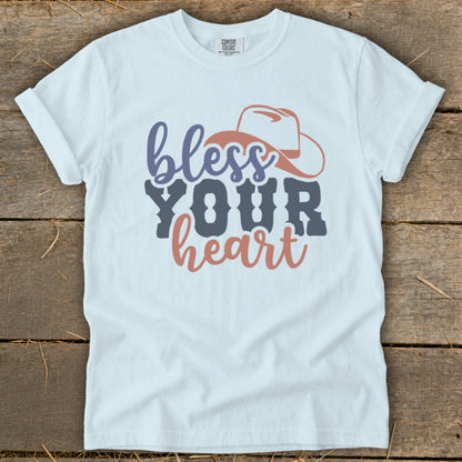 White t-shirt with "bless YOUR heart" and cowboy hat graphic.