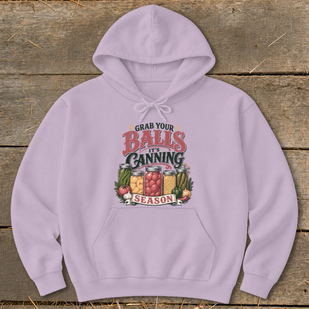 Lilac hoodie with "Grab Your Balls It's Canning Season" graphic and mason jars of food.
