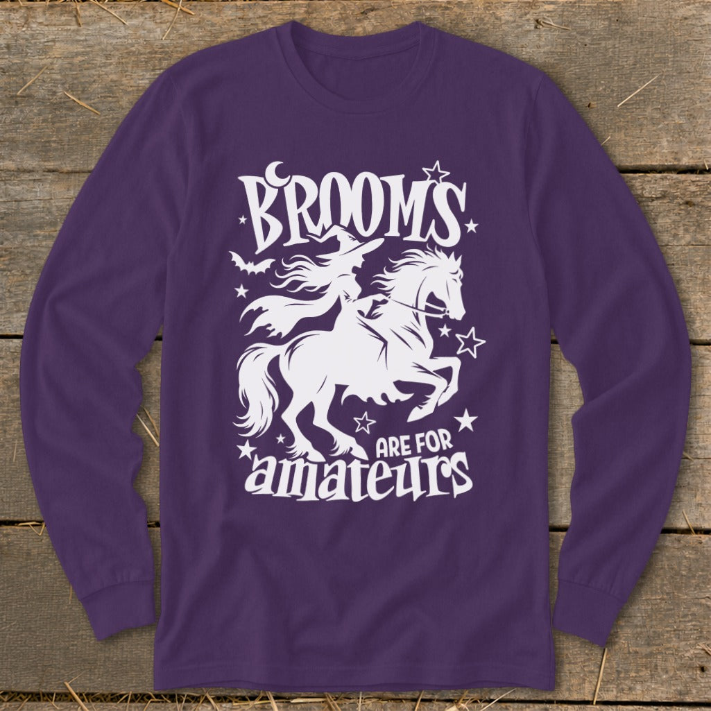 Purple long-sleeve shirt with "Brooms Are For Amateurs" and a witch riding a horse graphic.
