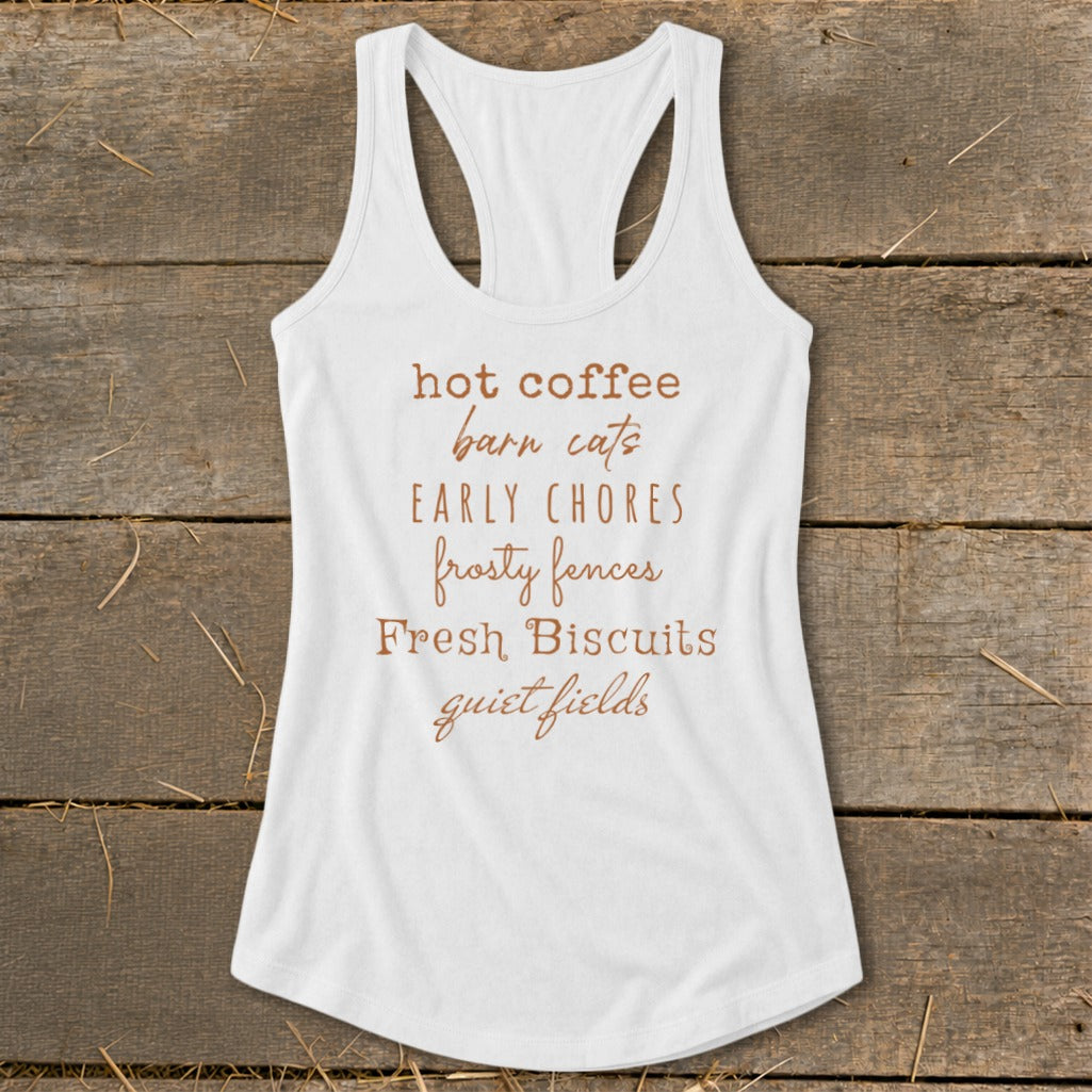 White tank top with text listing: hot coffee, barn cats, early chores, frosty fences, fresh biscuits, quiet fields.