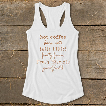 White tank top with text listing: hot coffee, barn cats, early chores, frosty fences, fresh biscuits, quiet fields.