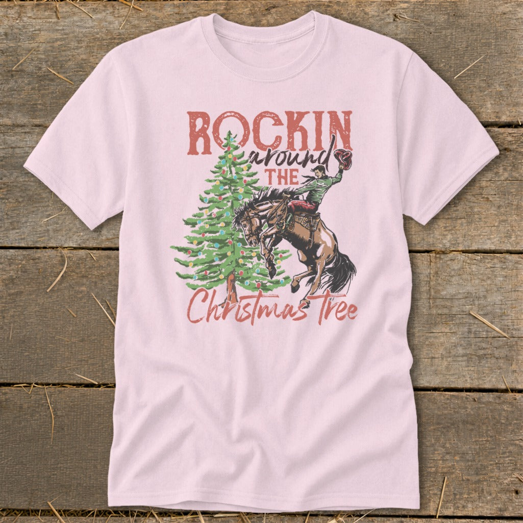 Pink t-shirt with "Rockin Around the Christmas Tree" graphic of a bucking bronco and rider.