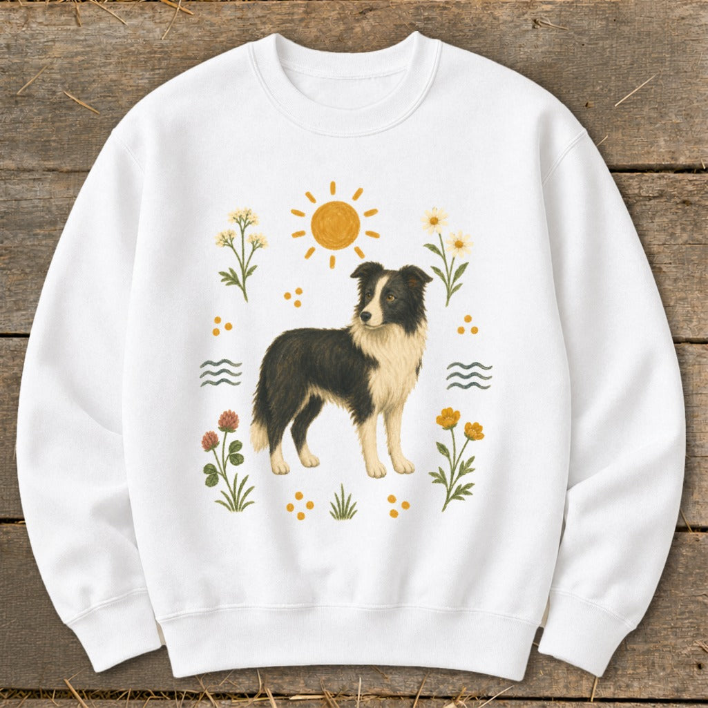 White sweatshirt with a Border Collie illustration surrounded by flowers and sun.