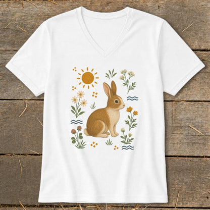 White v-neck t-shirt with a cartoon brown bunny, sun, and flowers graphic.