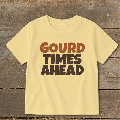 Light yellow t-shirt with brown text "GOURD TIMES AHEAD" in three lines.