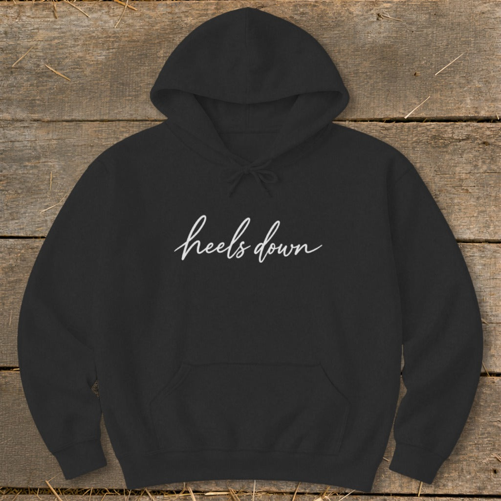 Black hoodie with white cursive text that reads "heels down."