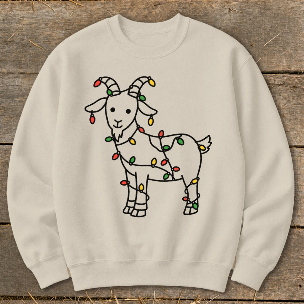 Cream sweatshirt with a cartoon goat wrapped in colorful Christmas lights.