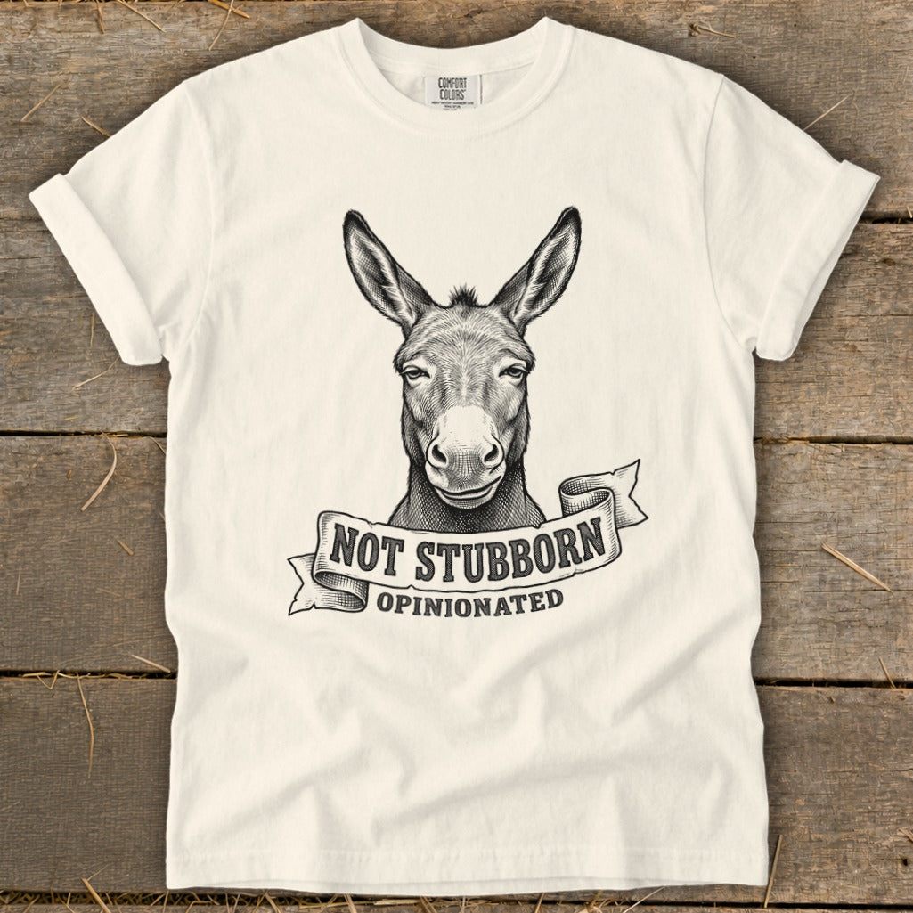 White t-shirt with a sketch of a donkey and text "NOT STUBBORN OPINIONATED".