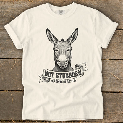 White t-shirt with a sketch of a donkey and text "NOT STUBBORN OPINIONATED".