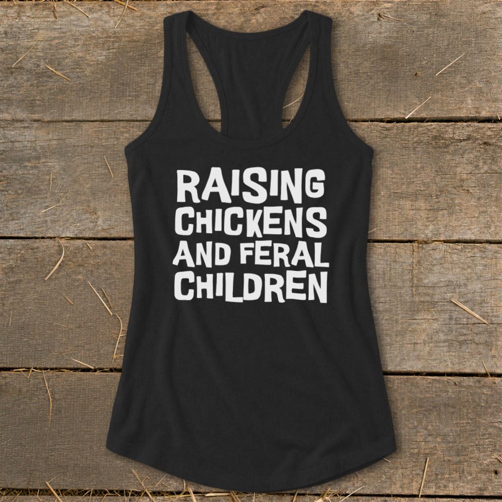 Black racerback tank top with white text reading "RAISING CHICKENS AND FERAL CHILDREN".