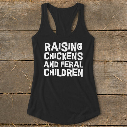 Black racerback tank top with white text reading "RAISING CHICKENS AND FERAL CHILDREN".