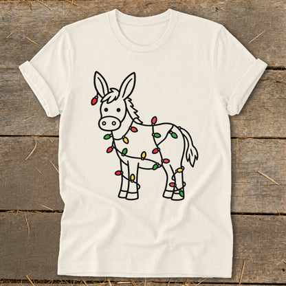 Cartoon donkey outlined in black, wrapped in colorful Christmas lights on a cream t-shirt.
