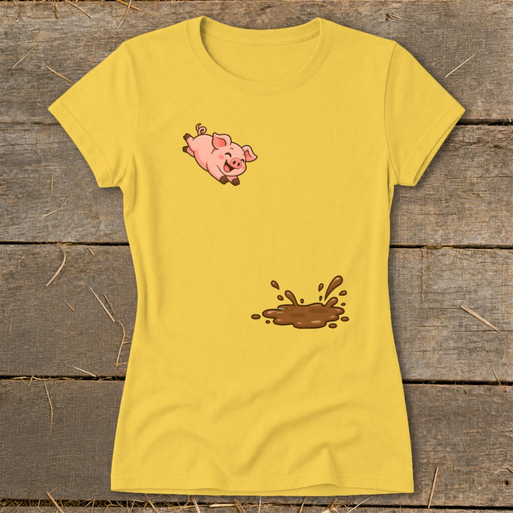Yellow t-shirt with a cartoon pig jumping above a mud splash graphic.