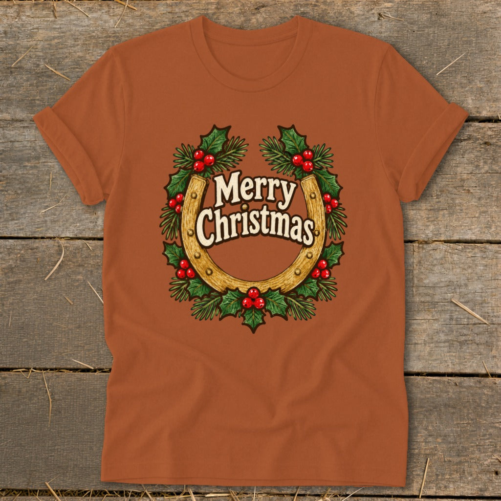 Orange t-shirt with horseshoe, holly, and "Merry Christmas" text graphic.