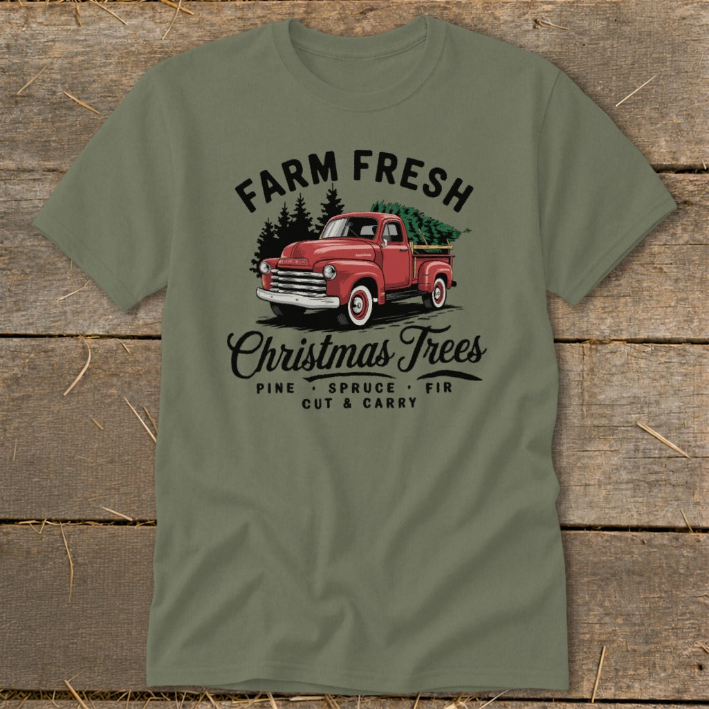 Green t-shirt with red truck carrying Christmas trees, "Farm Fresh Christmas Trees" text.