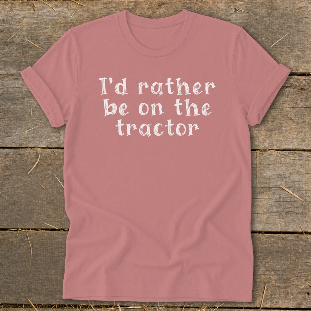 Pink t-shirt with white text reading "I'd rather be on the tractor."