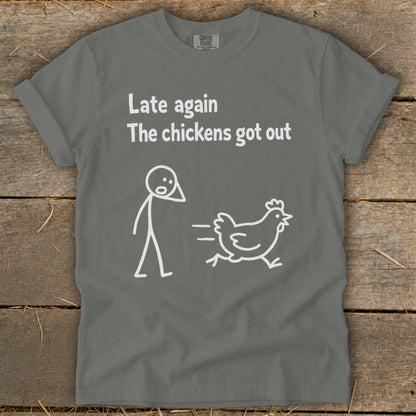 T-shirt with text "Late again the chickens got out" and stick figures.