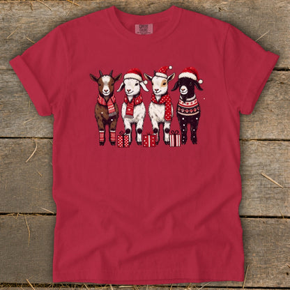 Four goats in Santa hats and scarves stand with gifts.